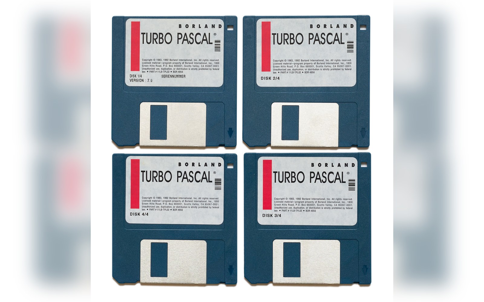 Four 3.5-inch floppy disks labeled Borland Turbo Pascal, numbered disk 1 through 4 of 4