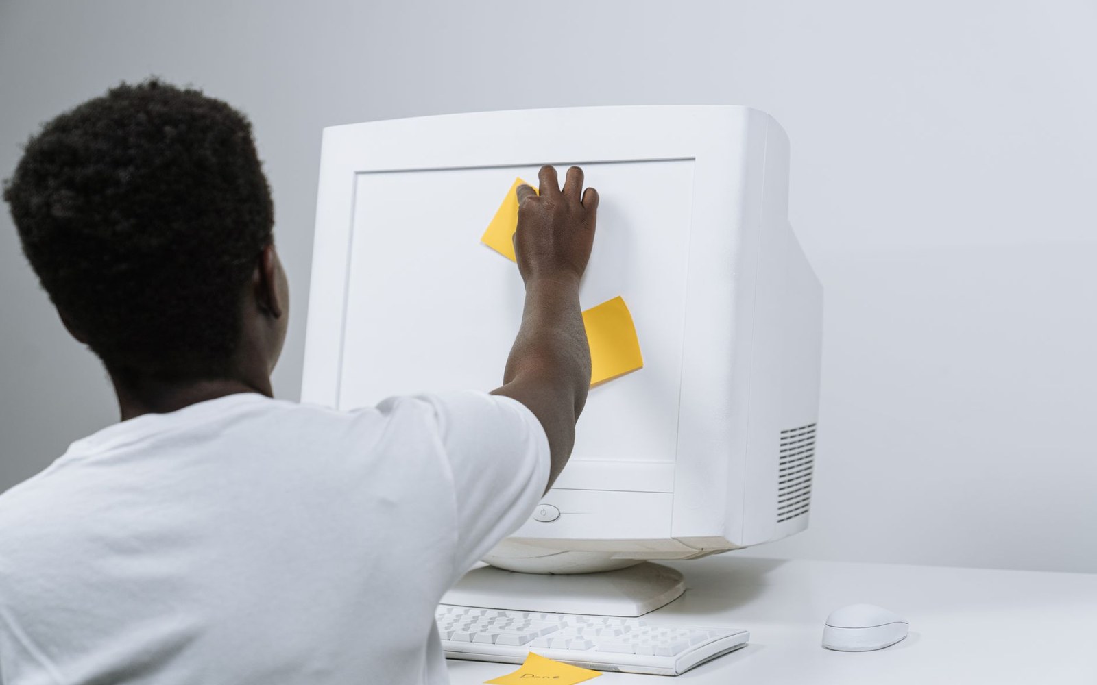 Delphi form designer mid-drag on a CRT monitor, component palette open at right, adult developer's hand on the mouse at the edge of the frame, screen the brightest light source in the room